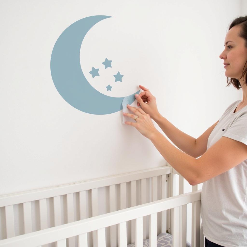 Applying removable wall stickers in a baby nursery