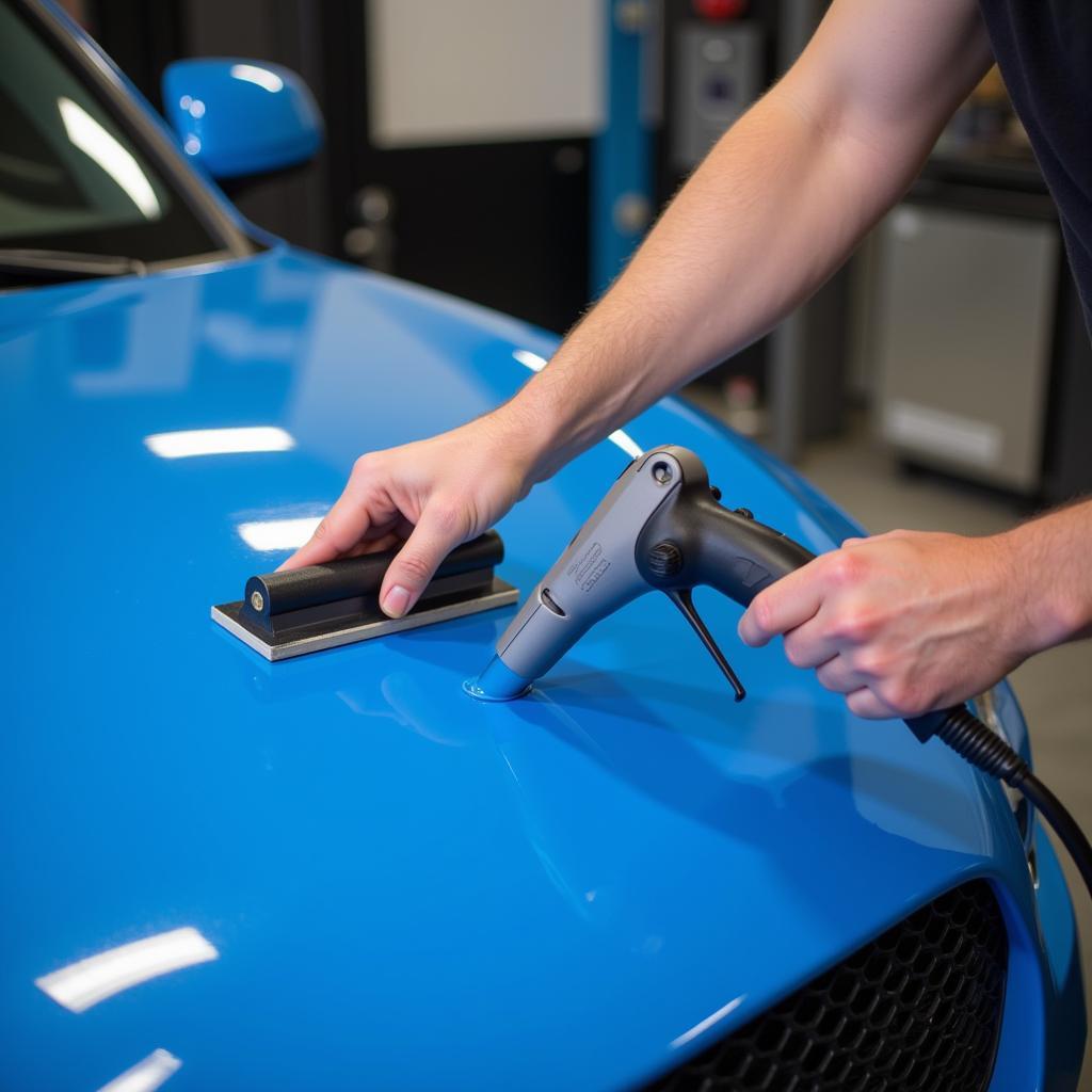 Applying Wrap Blue Vinyl on a Car with Precision