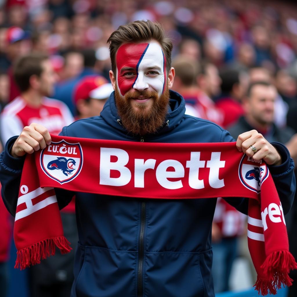 Football fan holding a Brett logo scarf