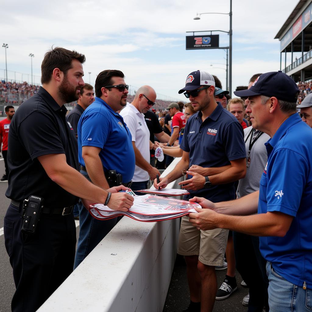 Christopher Bell signing autographs at the race track