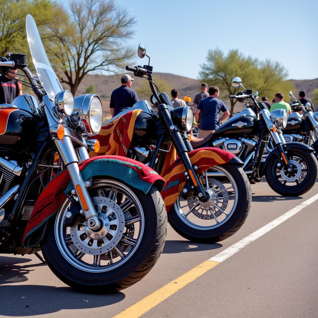 A variety of Mexican blankets displayed with motorcycles