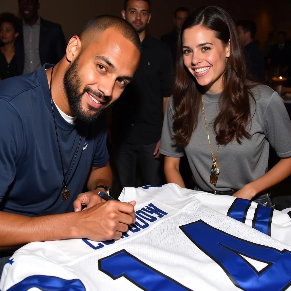 Drew Pearson signing a jersey for a fan