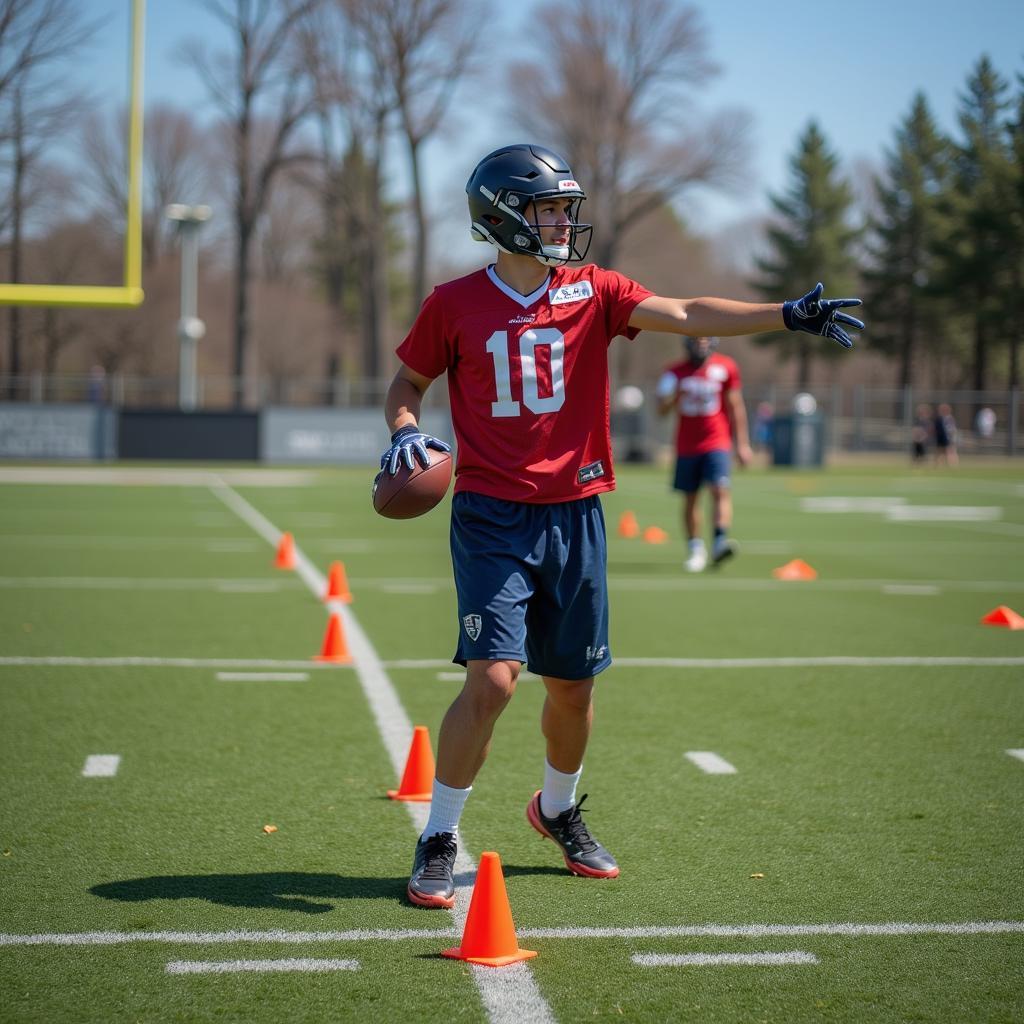 Football player practicing passing drills with cones