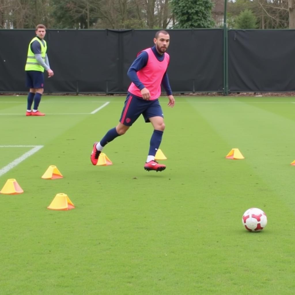 Football player honing their shovel glove skills with cone drills.