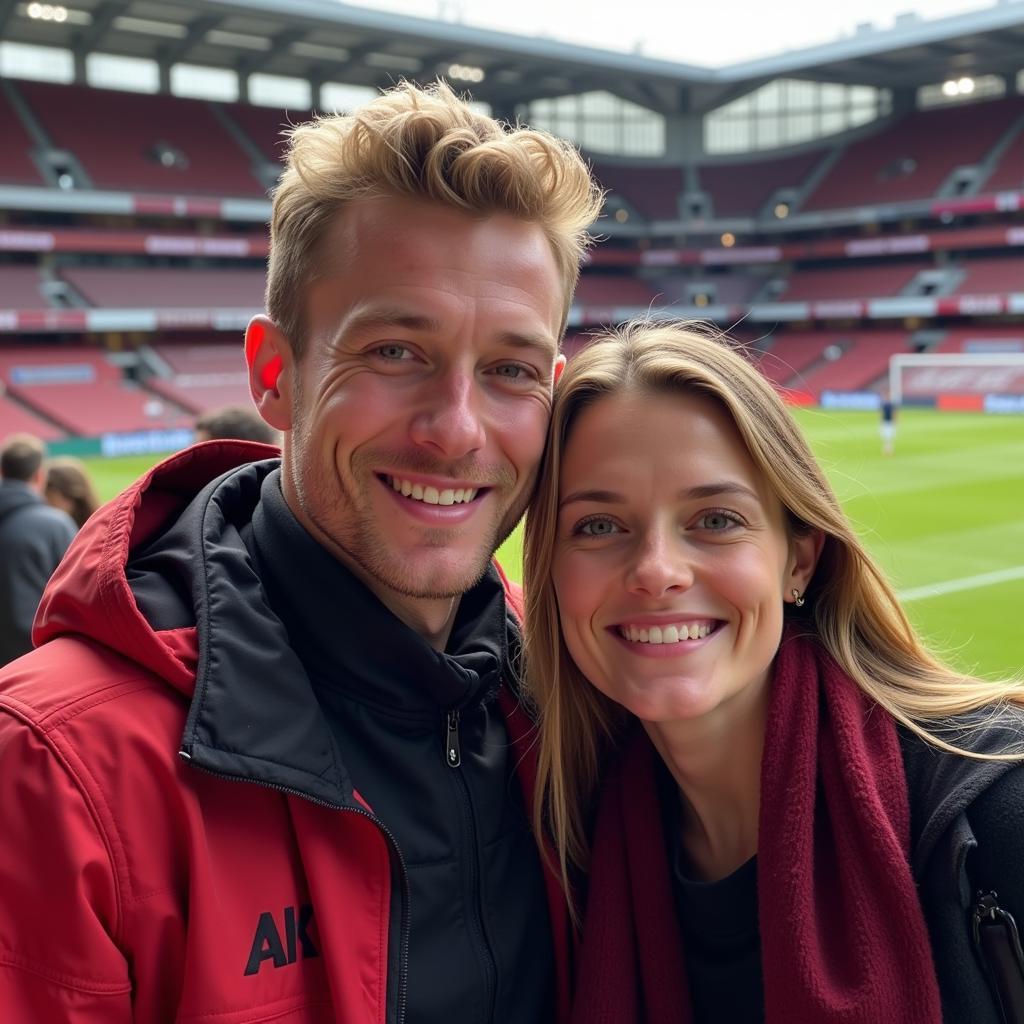 Frenkie de Jong and partner enjoying a football game