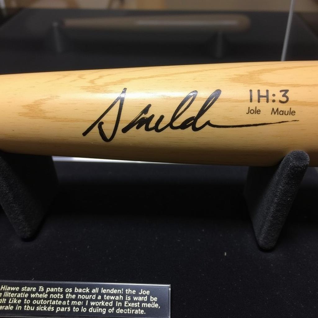 Joe Mauer autographed bat displayed in a protective case