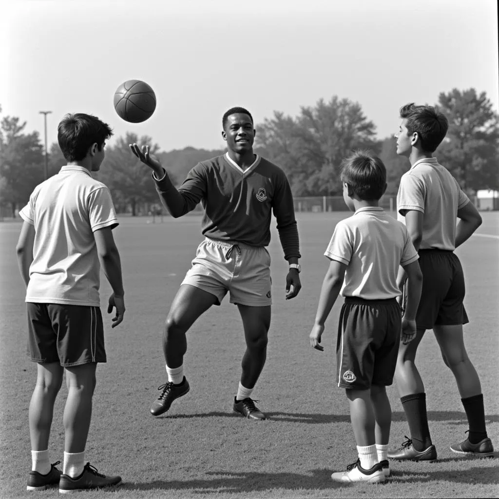 Marvin Webb demonstrating passing techniques to young footballers