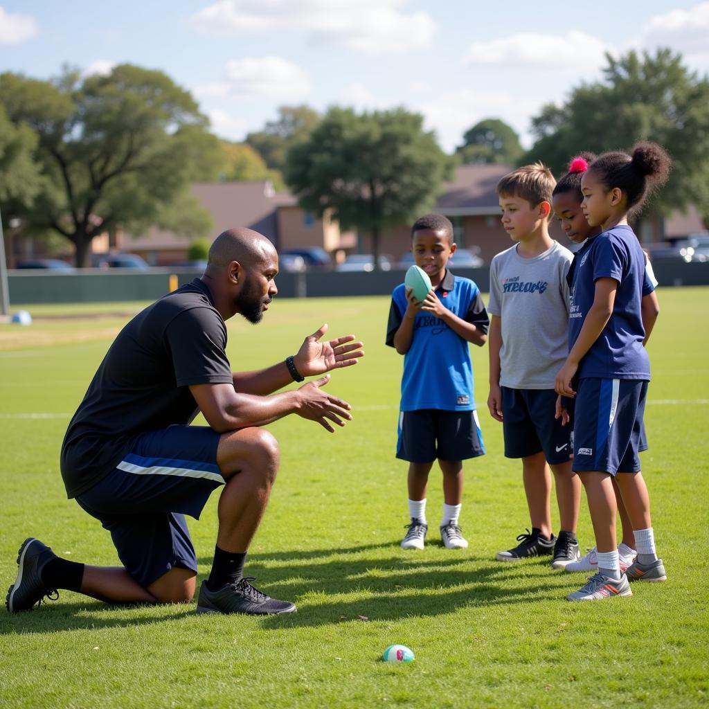 Richard Allred coaching a youth football team.