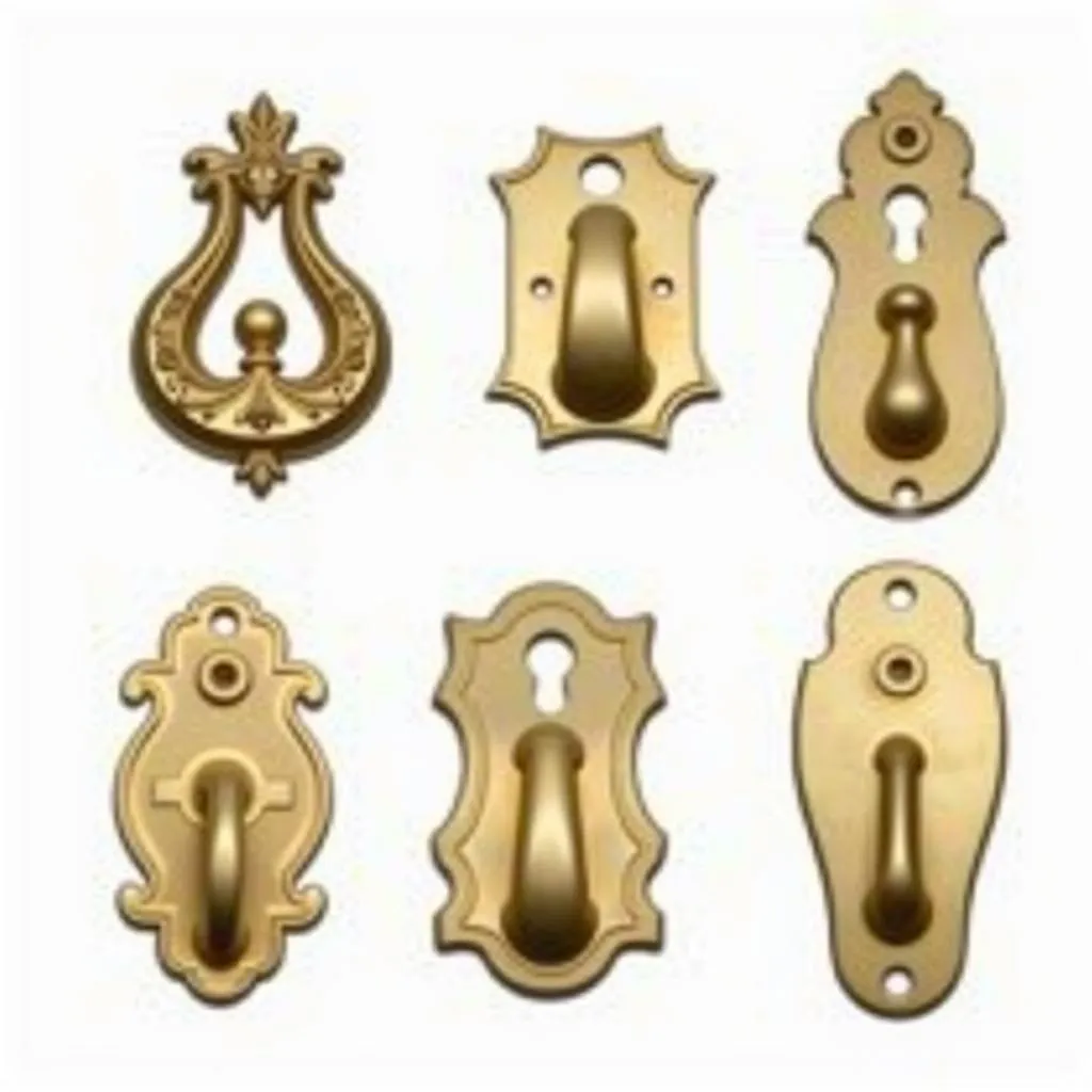 Different styles of brass purse hooks displayed on a table