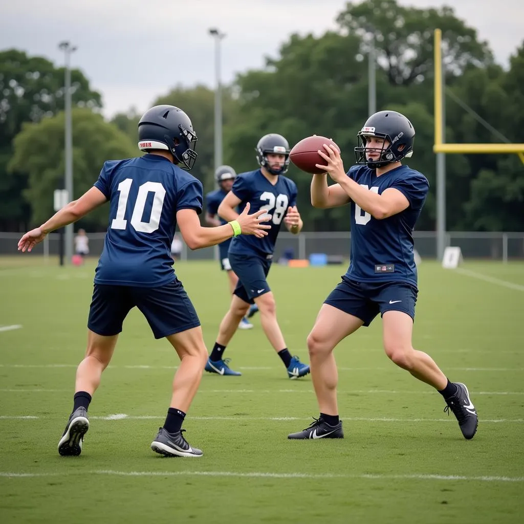 Young football players practicing passing drills during a training session