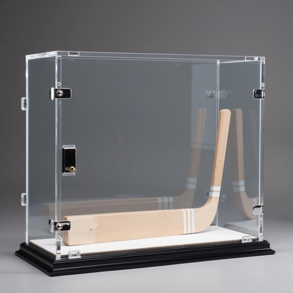 Tabletop acrylic hockey stick display case with a lockable feature.