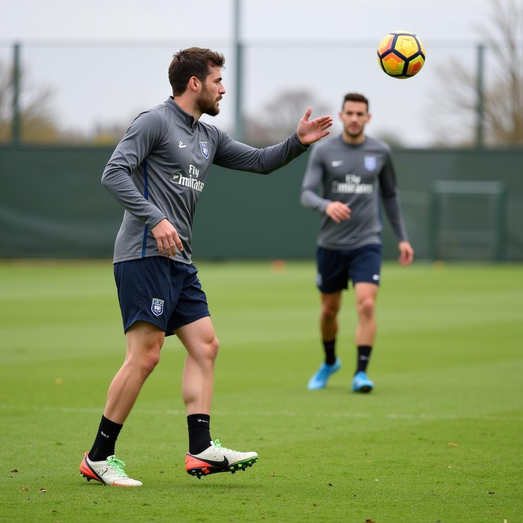 Football player honing his twisted sky high pass skills during training.