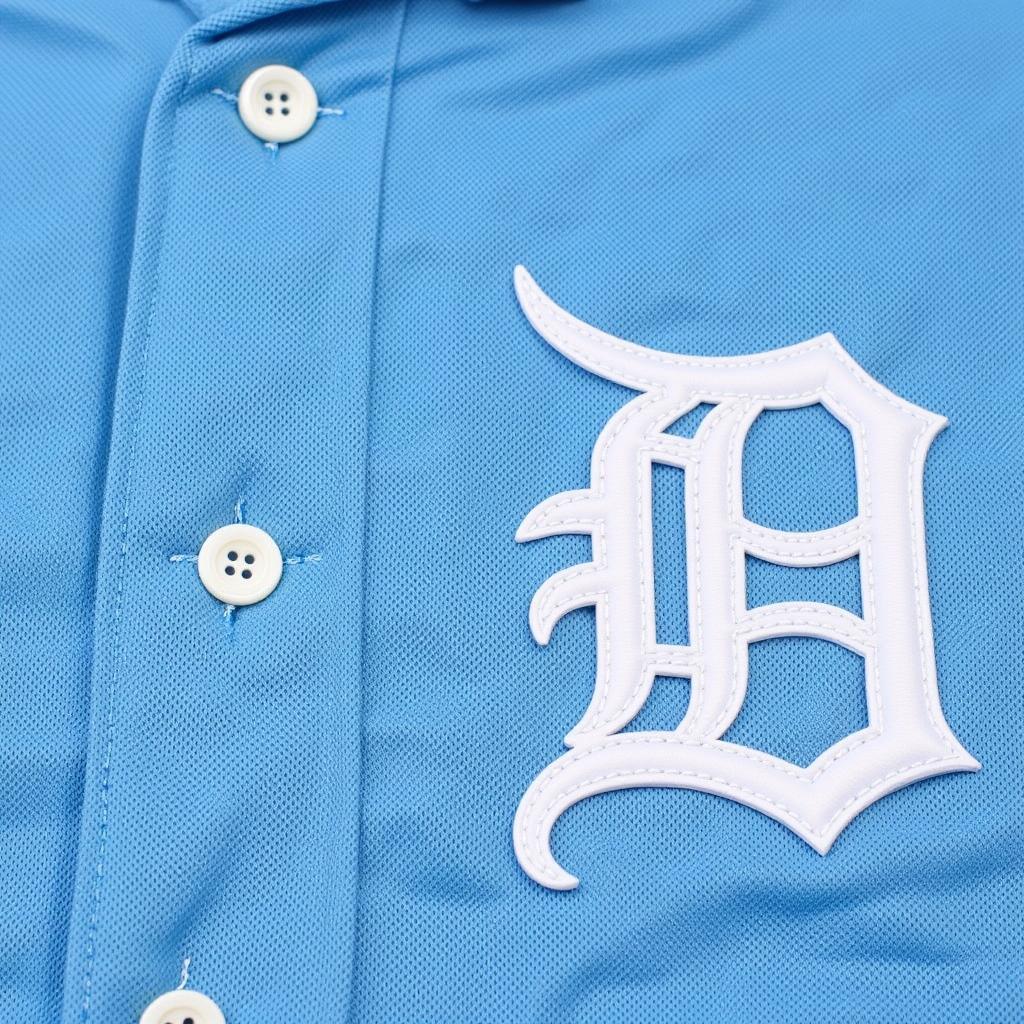 Close-up of a powder blue baseball uniform, highlighting the details like stitching and fabric.