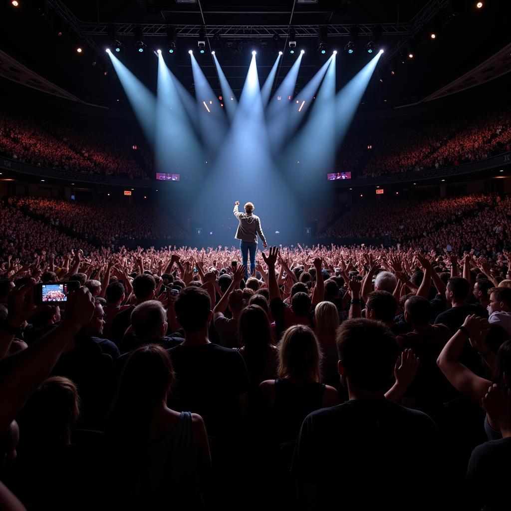 Fans cheering enthusiastically during Sam Hunt's performance in Philadelphia, wide shot showing the scale of the crowd