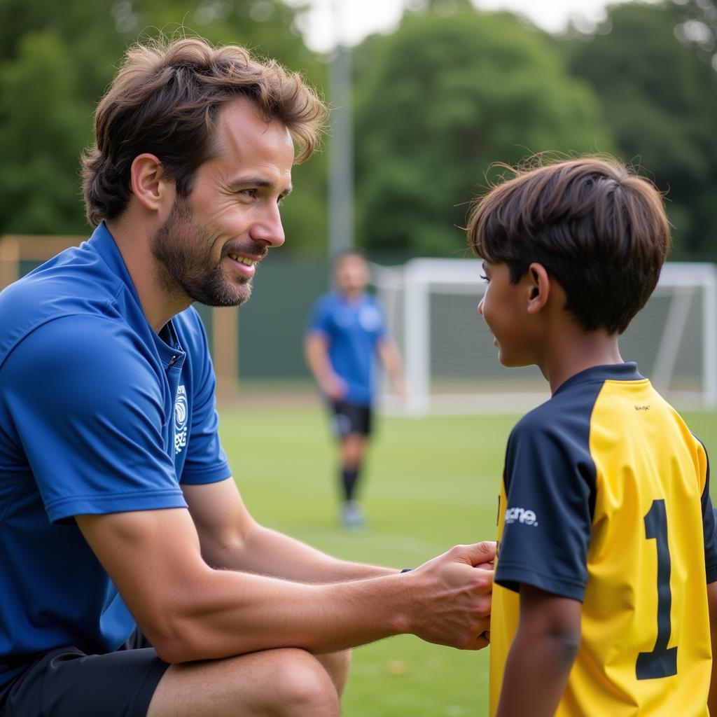 Youth Football Coach Mentoring: A coach providing guidance and support to a young player, emphasizing the importance of mentorship in youth football.