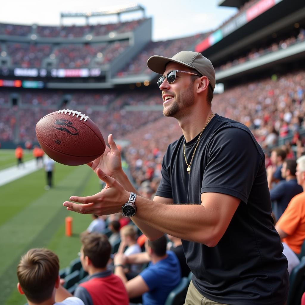 Fan catching a small football safely at a game