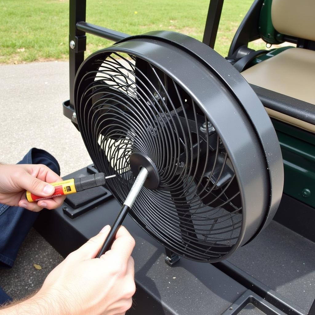 Installing a golf cart fan with mister onto a golf cart.