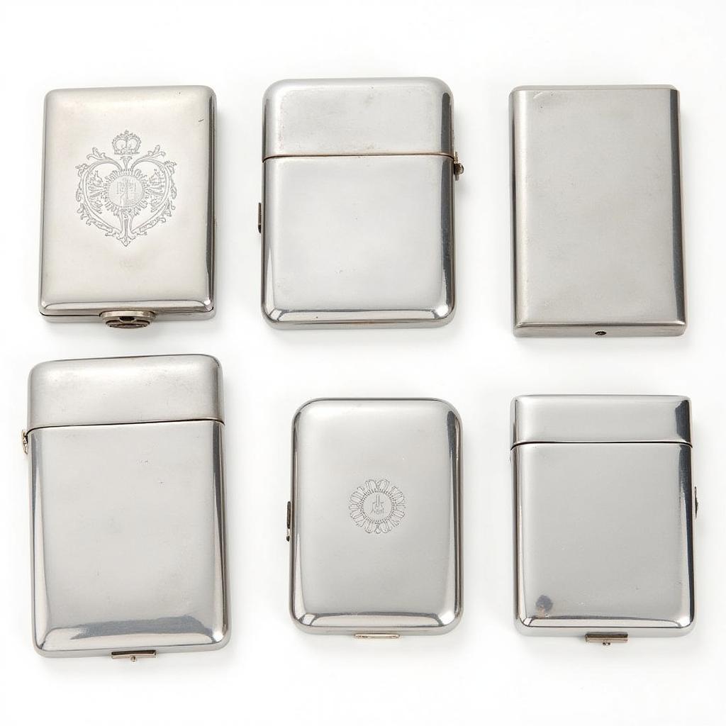 A collection of various stainless steel cigarette cases showcasing different sizes, designs, and finishes.